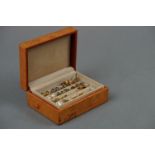 A vintage leather earring box containing 15 pairs of earrings.