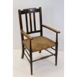 Arts and Crafts Elbow Chair with rush seat, 63cms wide x 98cms high