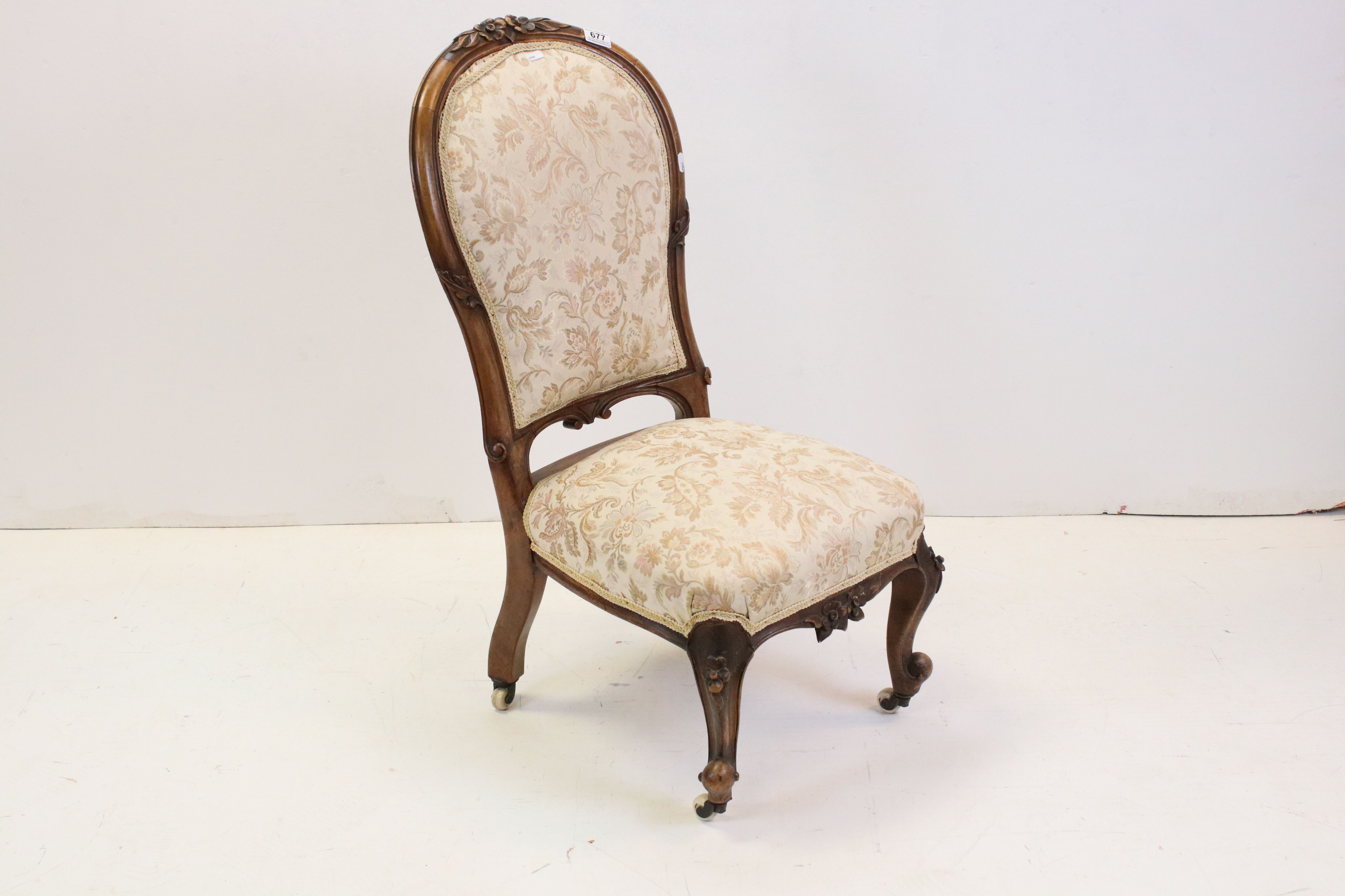 Victorian Walnut Framed Spoon Back Nursing Chair raised on ceramic castors, 87cms high