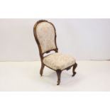 Victorian Walnut Framed Spoon Back Nursing Chair raised on ceramic castors, 87cms high