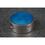 A fully hallmarked sterling silver pill box with blue guilloche enamel decoration to the lid.