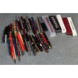 A collection of vintage pens and pencils to include Parker and Waterman's examples.