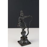 A bronze Hindu figure of Krishna dancing on the serpent.