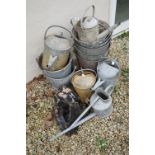 A collection of vintage galvanised steel buckets and watering cans together with two drain hoppers.