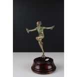 Art Deco figure in the manner of Lorenzl on wooden base.