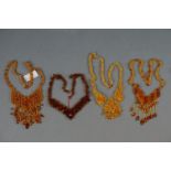 A collection of vintage amber style beaded necklaces.