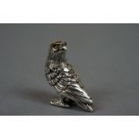 Silver figure of a red kite with glass eyes