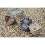 A group of three reconstituted stone planters together with two others.