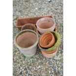 A collection of vintage terracotta garden plant pots.