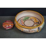 A large Japanese bowl with floral decoration together with a paperweight.