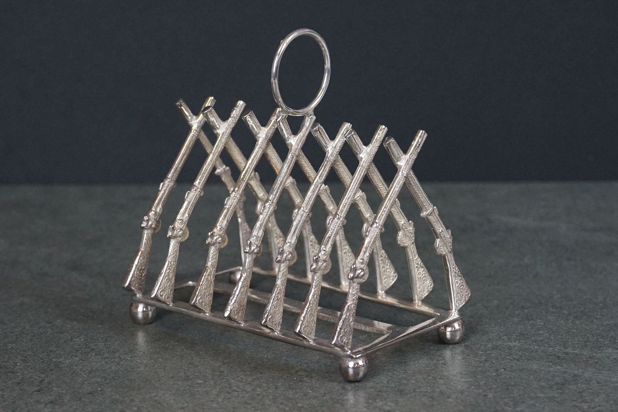 Silver plated toast rack in the form of rifles