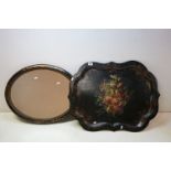 A large papier mâché lacquer ware tray with floral decoration together with a wall mirror.
