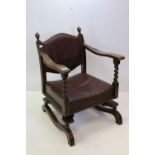 1930s oak cottage sprung rocking chair with sculptured leather upholstery