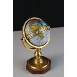 Brass and stone globe, on a marble base, with enamel numbers