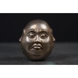 White metal four faced Buddha paperweight, signed with character marks