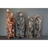 A collection of four oriental wooden carved figures to include two used as lamp bases.