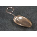A sterling silver tea caddy spoon with decorative bowl in the form of a leaf.