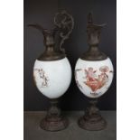 A pair of late 19th century glass and spelter urns with cherub decoration.
