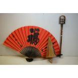 A vintage bamboo hunting stick together with a large oriental fan and a parasol