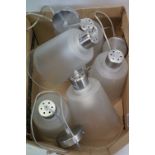 A set of five industrial style lamps with glass shades.