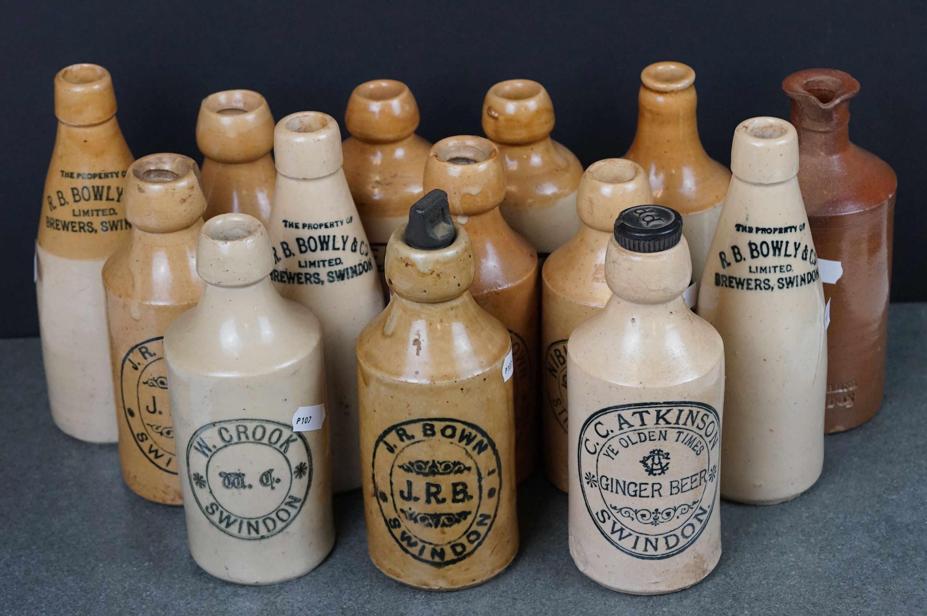 Collection of Fourteen Antique Stoneware Bottles, mostly Swindon Ginger Beer Bottles