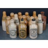 Collection of Fourteen Antique Stoneware Bottles, mostly Swindon Ginger Beer Bottles