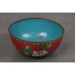 A vintage oriental cloisonné bowl with floral decoration.