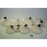 A collection of seven industrial style ceiling lamps.