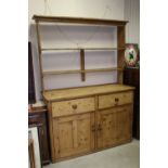 Victorian pine kitchen dresser of two drawers and two cupboards, with a rack above