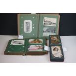 A large collection of antique postcards contained within three period postcard albums.