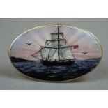 A vintage Scandinavian silver and enamel brooch with a sailing ship at sea.