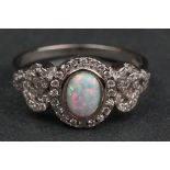 Silver and CZ ring with central opal panel