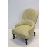 Victorian Spoon Back Upholstered Nursing Chair raised on turned front legs and castors, 84cms high