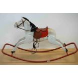 A vintage white rocking horse on red metal runners.