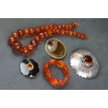 A small quantity of vintage costume jewellery to include amber style beaded necklace and two