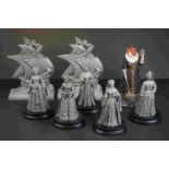 A collection of pewter figures of English queens together with cast metal Mary Rose bookends.