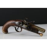 An early 19th century flintlock pistol, walnut stock with brass barrel and fittings, indistinctly