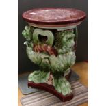 Majolica Ceramic Seat / Stand, the circular top over a base formed from three green glazed lions,