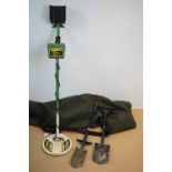 A vintage Garrett metal detector with accessories.