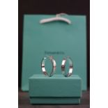 A Tiffany & Co 925 sterling silver pair of earrings complete with box and gift bag.