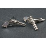 Interesting pair of silver pistol shaped cufflinks with mother of pearl handles