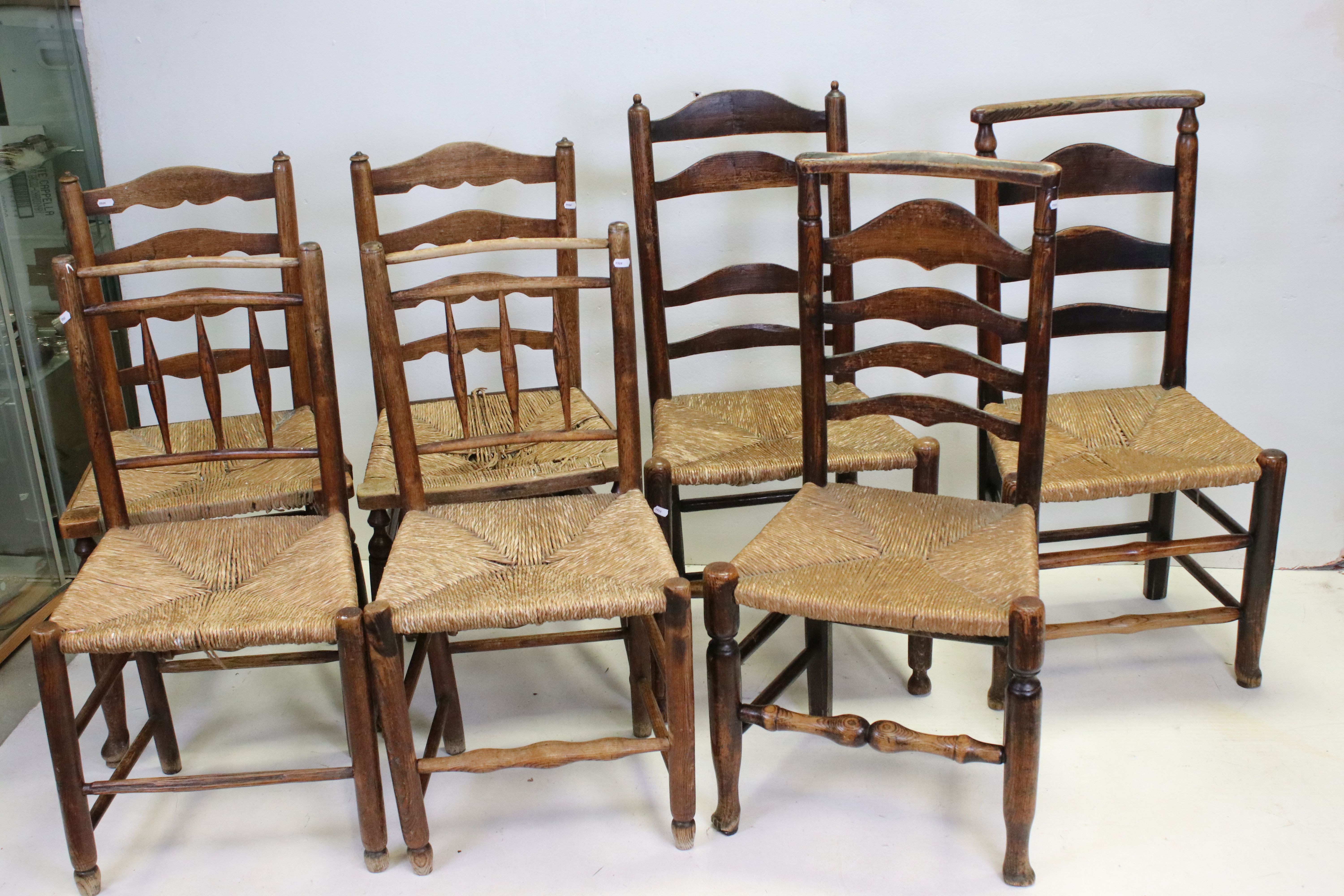 Three Pairs of Oak Ladder Back Chairs with Rush Seats together with one other similar chair