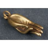 Brass pendant in the form of a hand