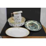 An early 20th century wash jug and basin together with two serving platters.