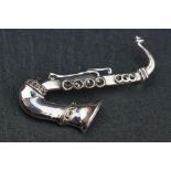 Silver saxophone shaped brooch