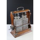 Antique "Holdfast" Tantalus by Walker & Hall of Sheffield with two cut glass decanters.