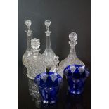 A collection of five glass decanters to include a ships example together with a pair of blue glass