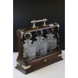 Late 19th / Early 20th century Oak and Silver Plate Mounted Tantalus with three matching cut glass