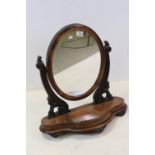 Victorian Walnut Oval Swing Mirror on shaped platform base with hinged lid glove box, 68cms high