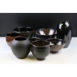 Collection of Studio Porcelain including a Vase (18cms high) and Seven Bowls, all with a black or